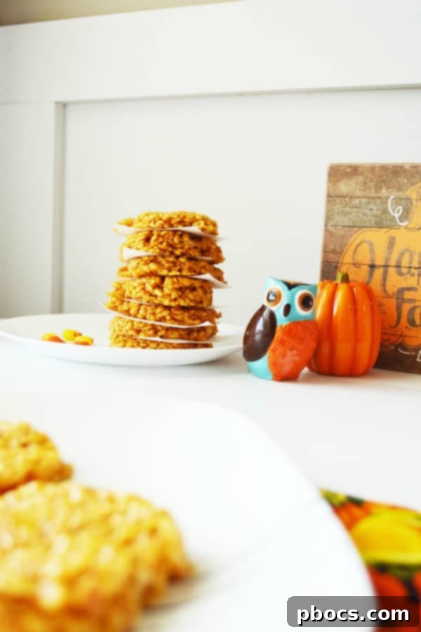 Pile of pumpkin-shaped Rice Krispie treats, ready for a Halloween party.