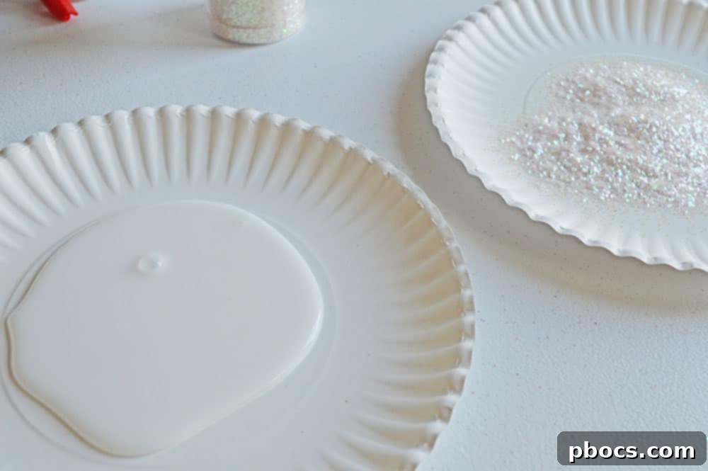 Two paper plates, one filled with white glue and the other with iridescent glitter, ready for crafting.