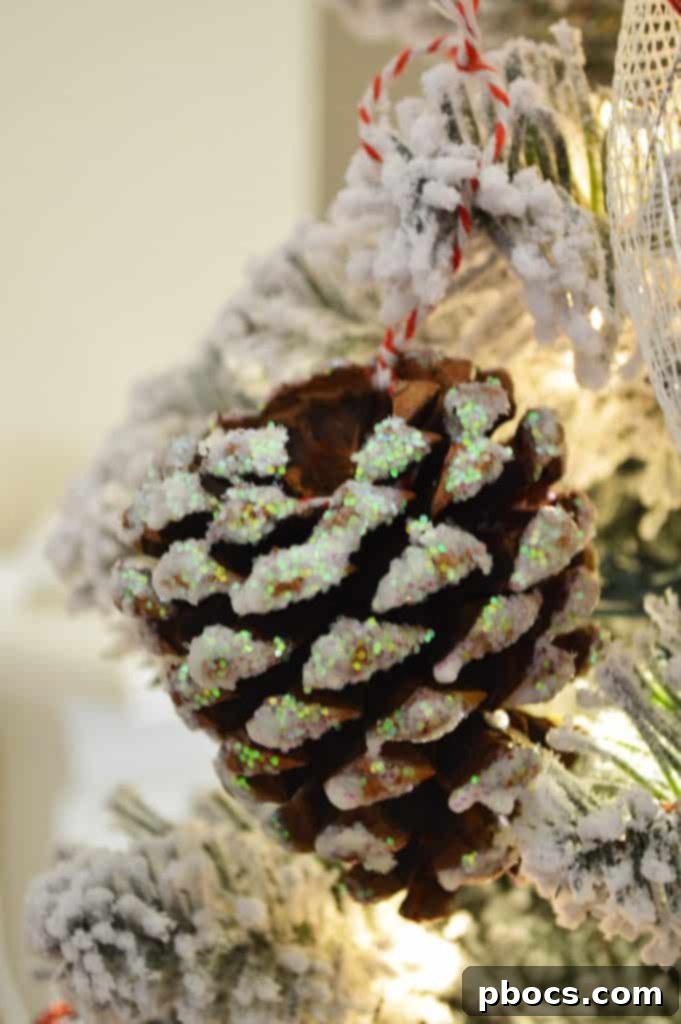 A clear glass bowl filled with dazzling DIY glitter pine cone ornaments, perfect for holiday display.