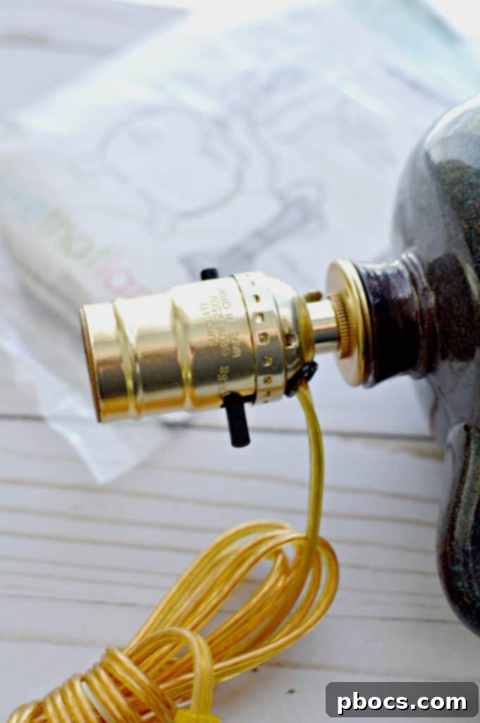 Inserting the assembled lamp into the bottle