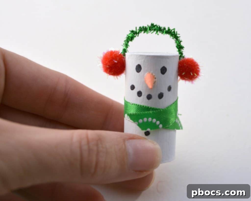DIY Wine Cork Snowman: Adding Pom-Pom Earmuffs Gluing small pom-poms for snowman earmuffs