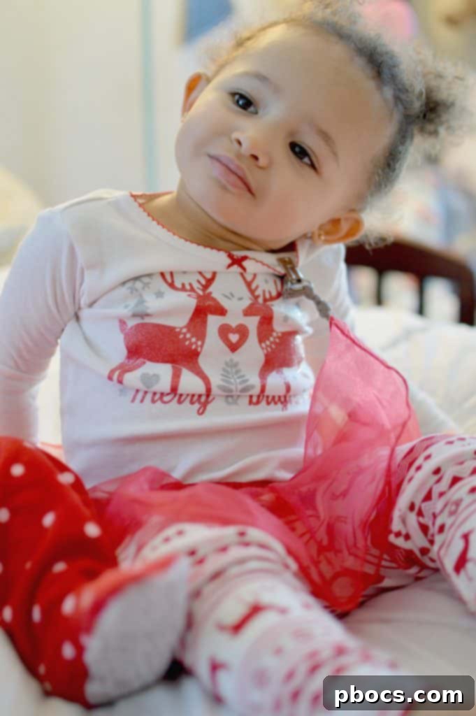 Our Favorite Holiday Pajamas - A young girl giggling in cozy sleepwear