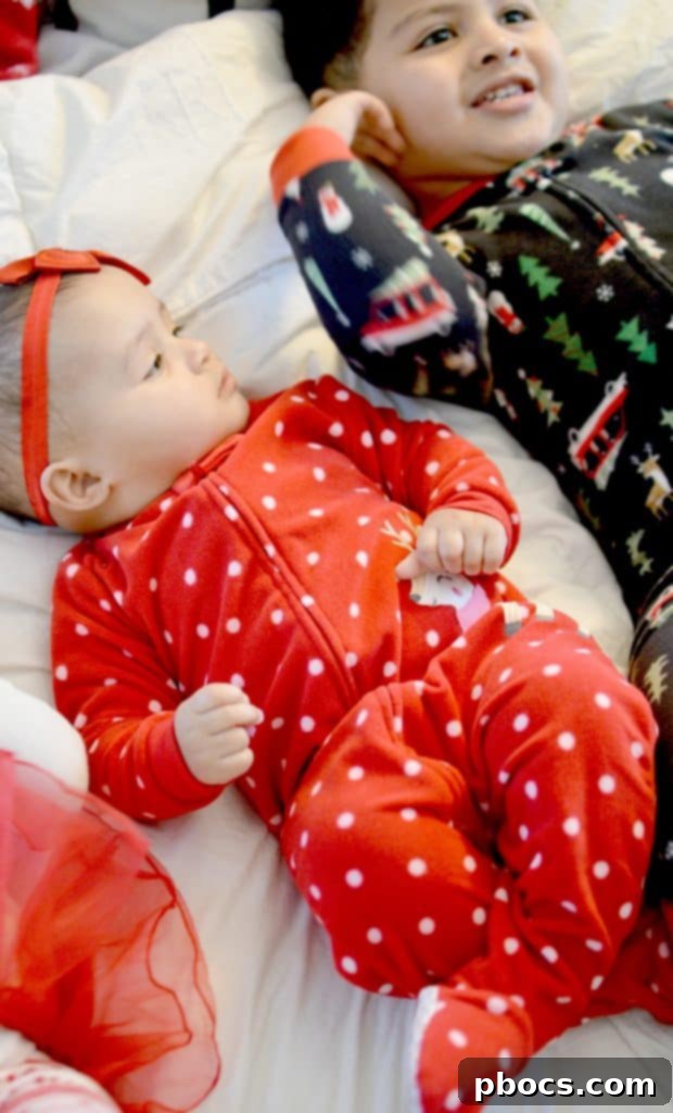 Our Favorite Holiday Pajamas - Girl reading a book in pajamas with a festive ornament
