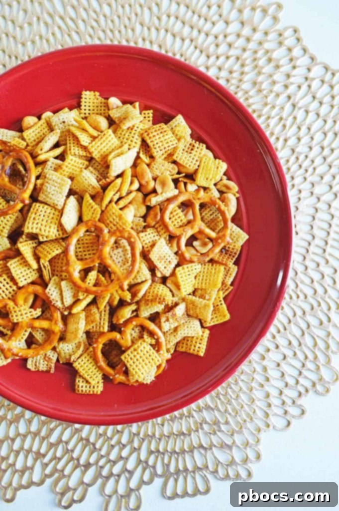 Irresistible Slow Cooker Chex Mix 2 Delicious homemade Chex Mix in a bowl, ready to be enjoyed.