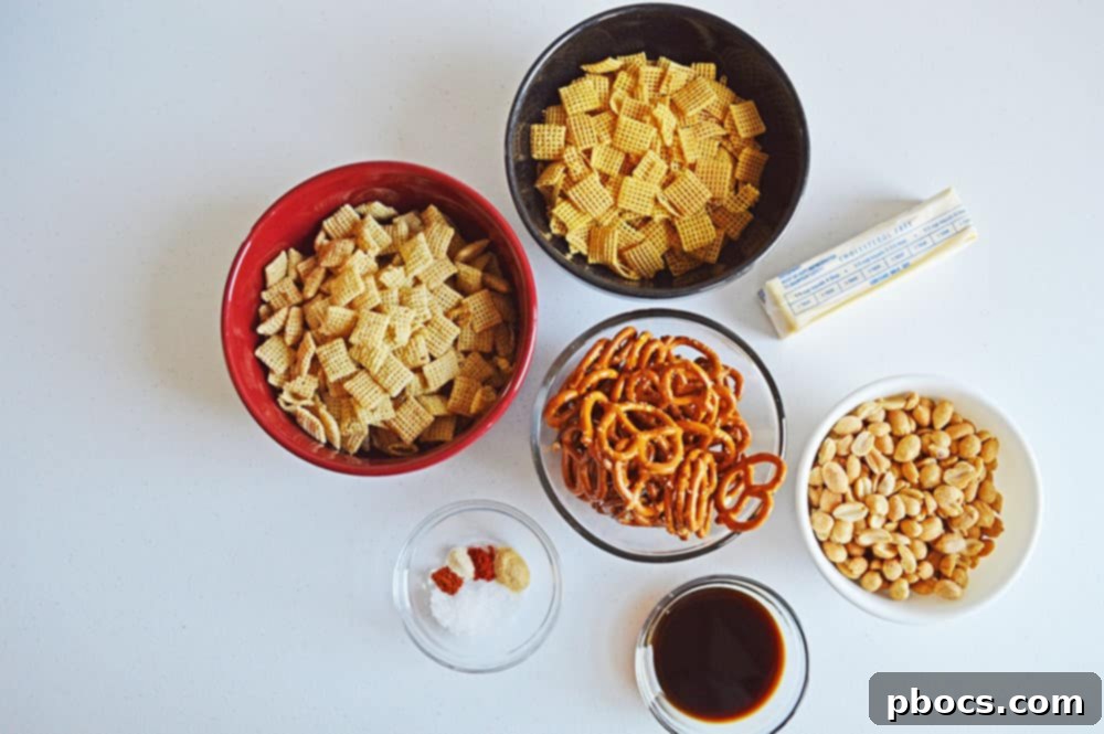 Irresistible Slow Cooker Chex Mix 3 All the ingredients for homemade Chex Mix laid out on a table.
