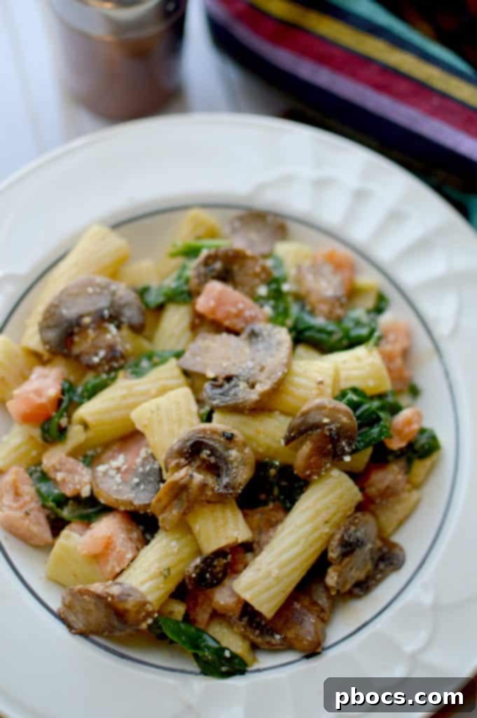 Close-up of creamy cajun rigatoni with mushrooms and spinach