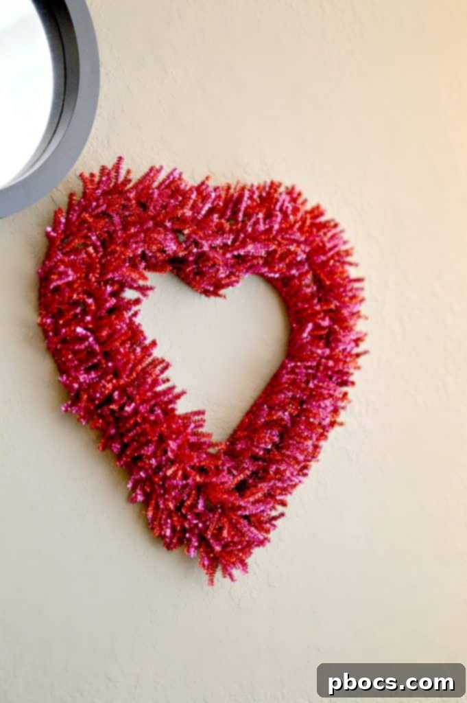 Heart-shaped pipe cleaner wreath in pink and red colors for Valentine's Day