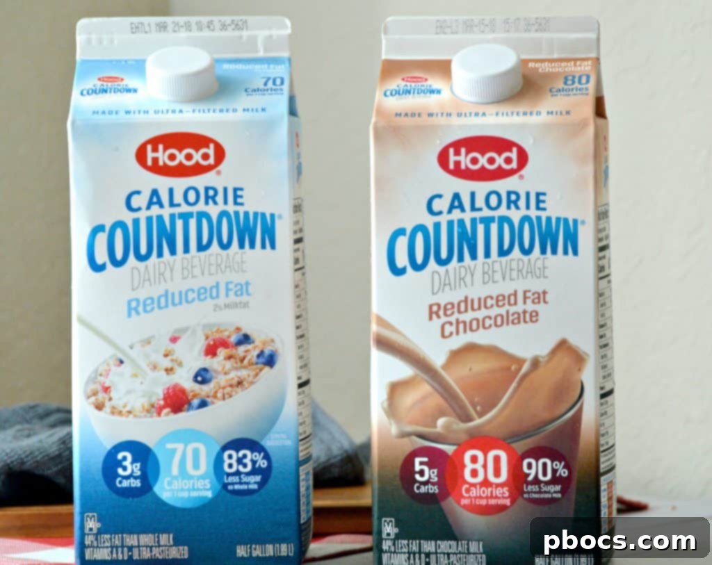 Block by Block: Masterful Calorie Management 2 A refreshing glass of Hood Calorie Countdown milk next to a carton, highlighting its natural goodness and healthy benefits.