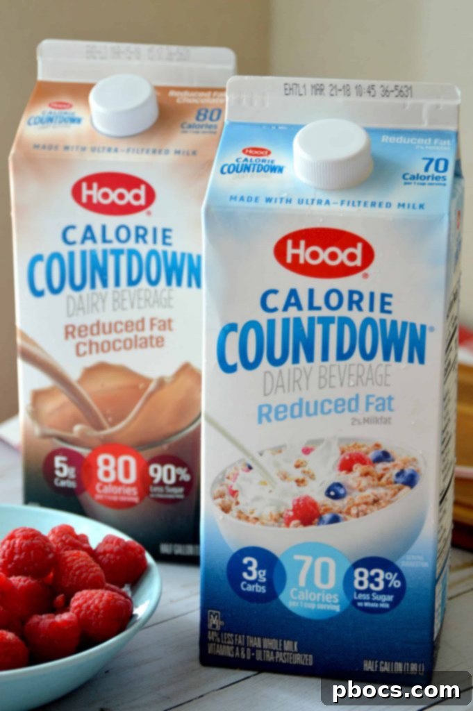 Block by Block: Masterful Calorie Management 3 A person pouring Hood Calorie Countdown milk into a glass, showing its smooth, creamy texture and inviting appearance.
