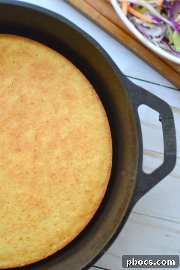 Spreading tartar sauce on the hush puppy pizza crust