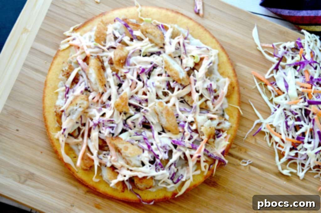 Assembling the Beer Battered Fish Pizza with fish and coleslaw