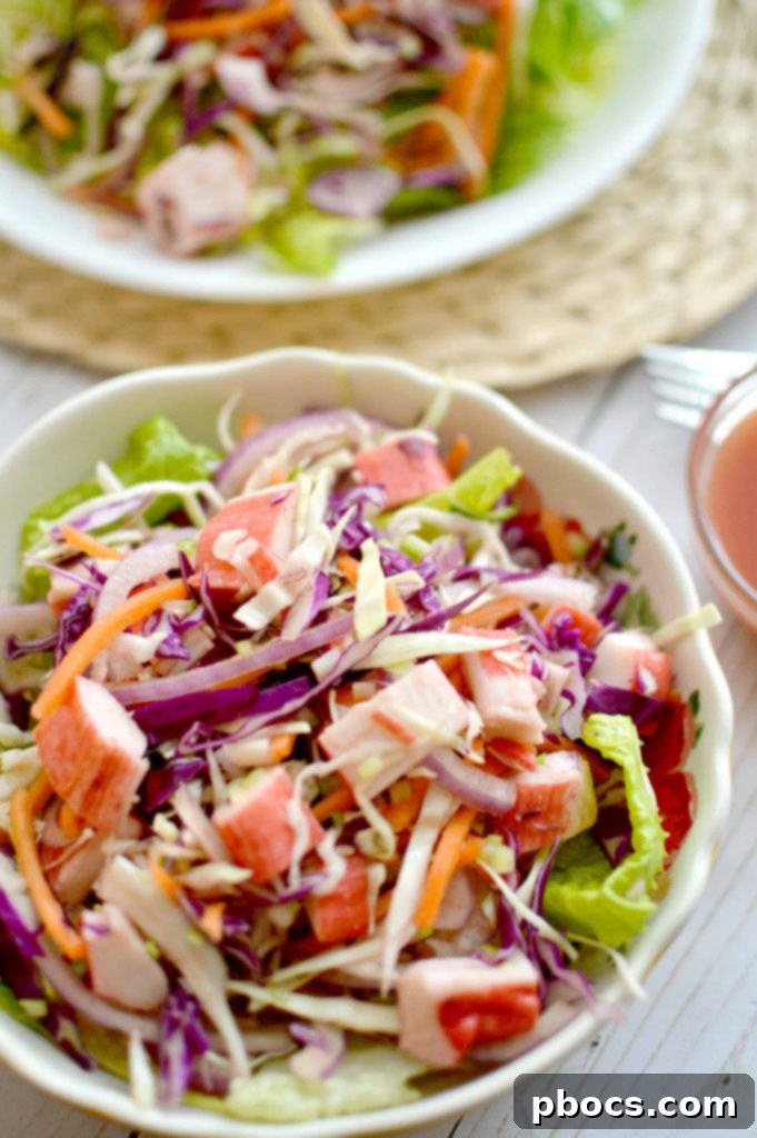 A large bowl of Crab Coleslaw Salad with Spicy Clamato Dressing, ready to be served.
