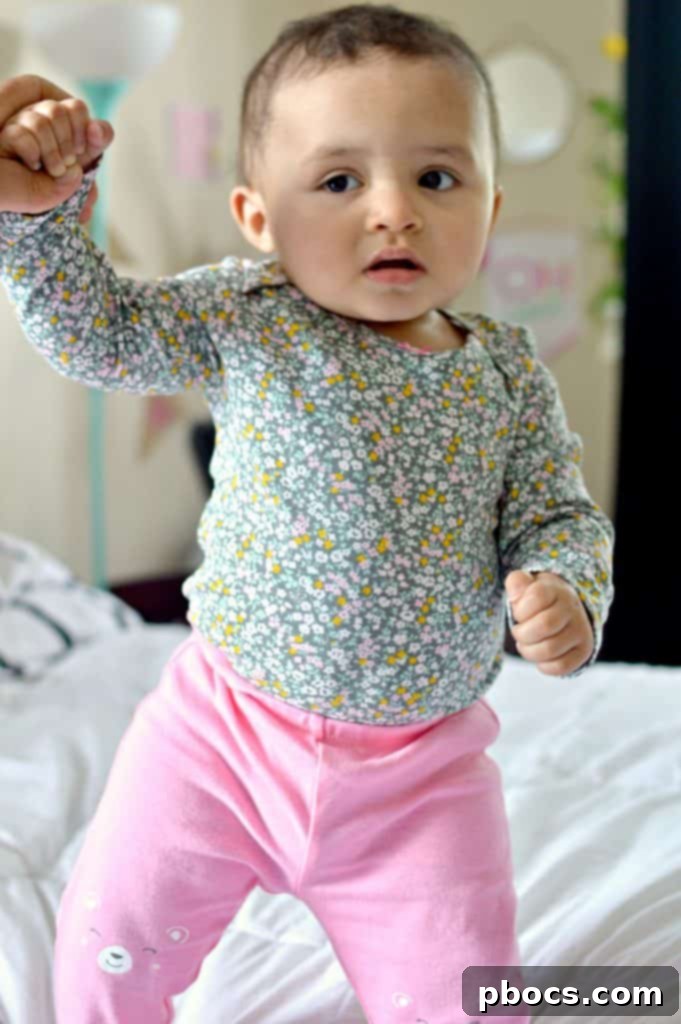 Close-up of baby Lauren with a captivating smile, her expressive eyes shining, dressed in a comfortable Carter's outfit.