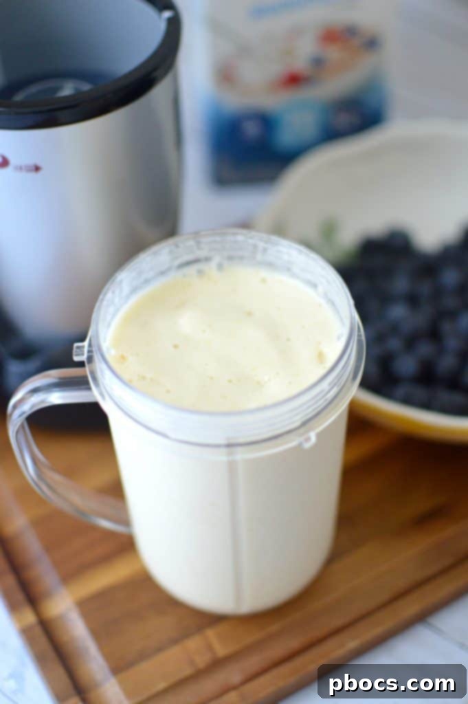 Tropical Dream Banana Pineapple Bowl 5 Blending the creamy banana pineapple smoothie base with Hood Calorie Countdown for a thick consistency