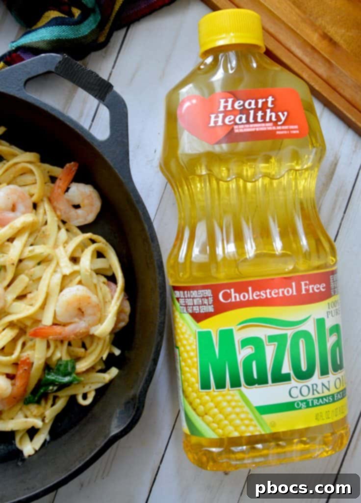 Final plating of Skinny Cajun Shrimp Fettuccine Alfredo, showcasing a generous portion of pasta, shrimp, and spinach, ready to be served.