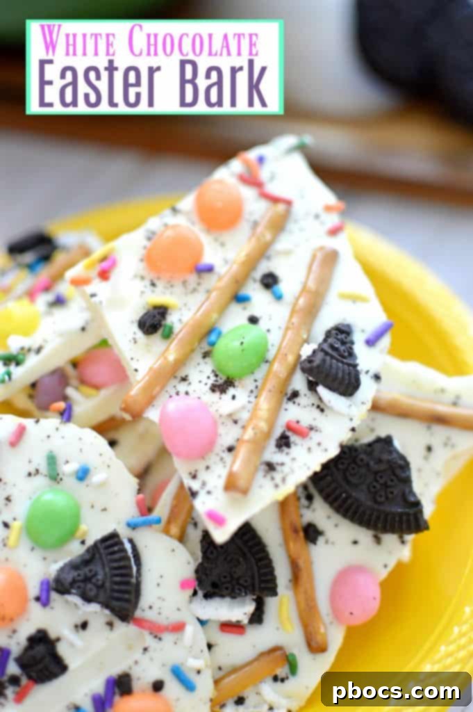 Vibrantly decorated white chocolate Easter bark with colorful jelly beans, crushed cookies, and sprinkles on a parchment-lined baking sheet, ready for Easter celebrations.