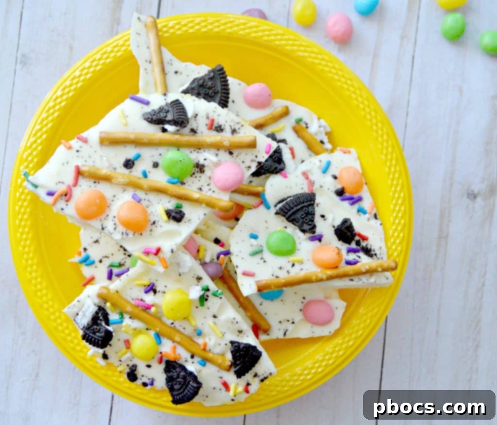 A close-up shot of the finished white chocolate Easter bark with all its colorful toppings, ready to be broken into pieces.