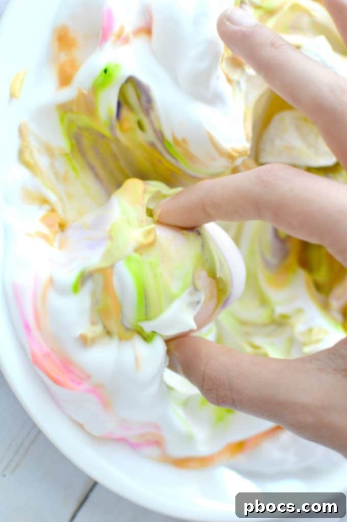 Dropping various food colorings onto shaving cream and swirling them gently with a toothpick to create marble patterns.