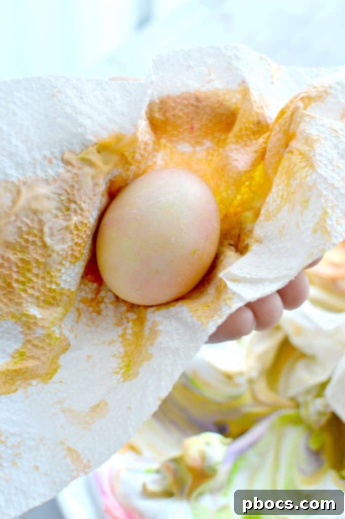 Gently rolling hard-boiled eggs through the colored shaving cream to pick up marbled patterns.