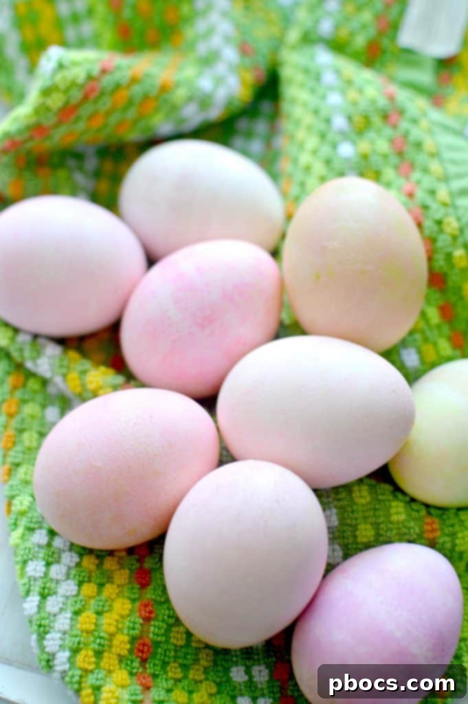 A close-up view of an egg being rolled in shaving cream, showing the color transfer process.