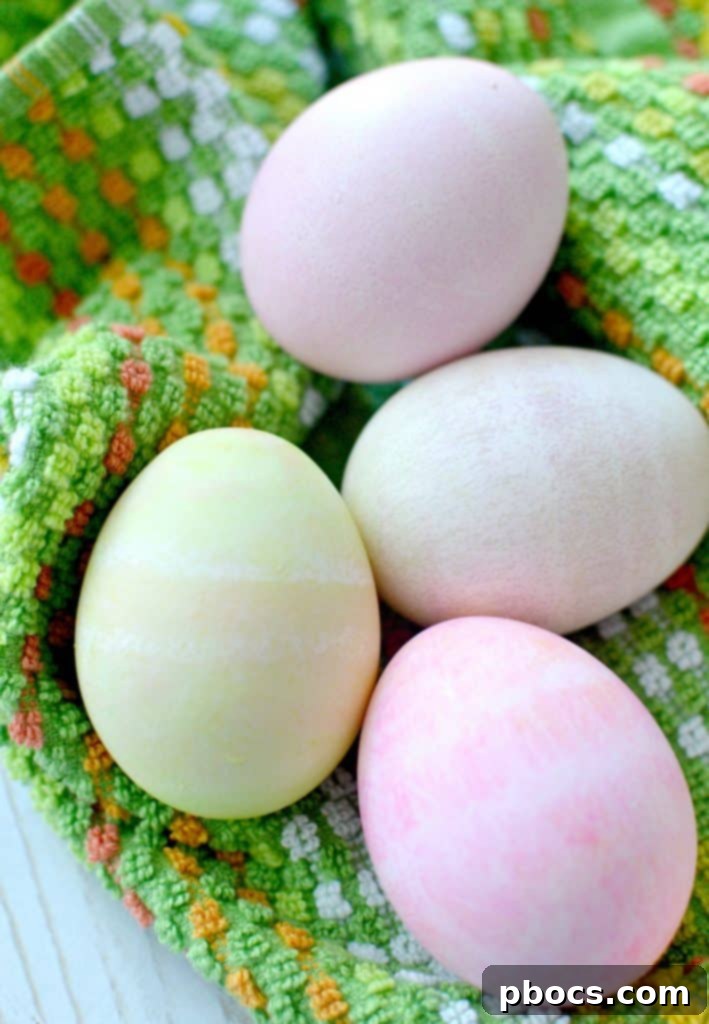 Multiple hard-boiled eggs covered in colored shaving cream, resting after being rolled.