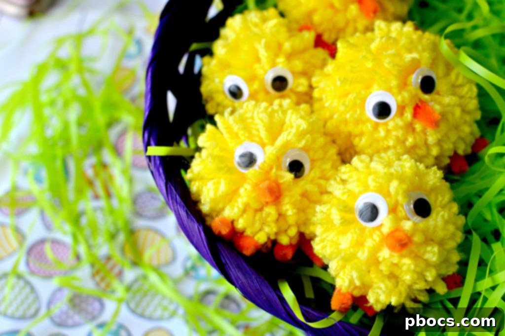 Craft Adorable Pom Pom Chicks Easily 2 Completed DIY Pom Pom Chick sitting on a wooden surface