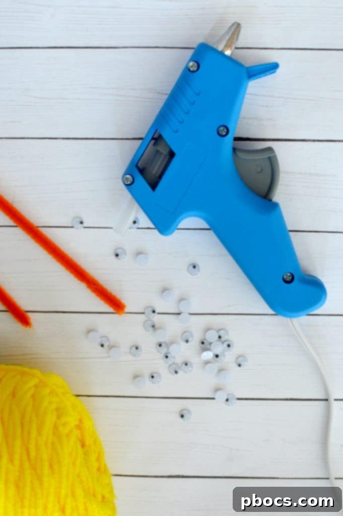 Craft Adorable Pom Pom Chicks Easily 3 Craft supplies laid out for making pom pom chicks