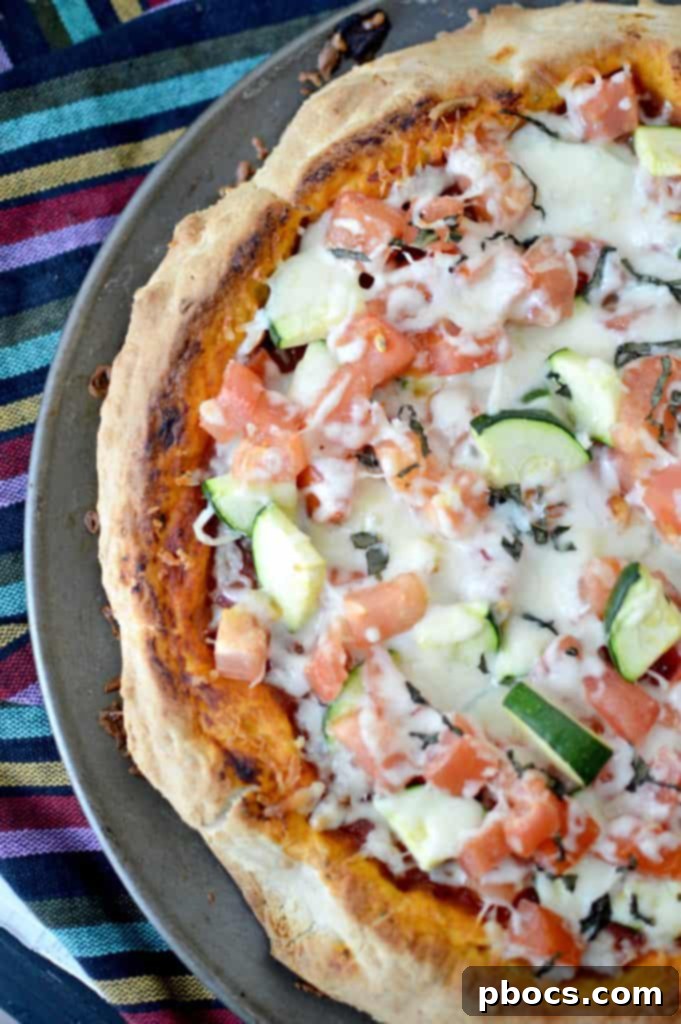 Fresh From Florida Tomato & Zucchini Family Pizza baking in the oven, showing golden crust