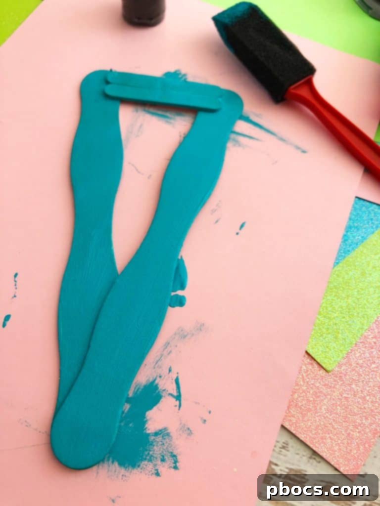 Simple DIY Mermaid Tail 5 Painting the craft stick mermaid tail frame