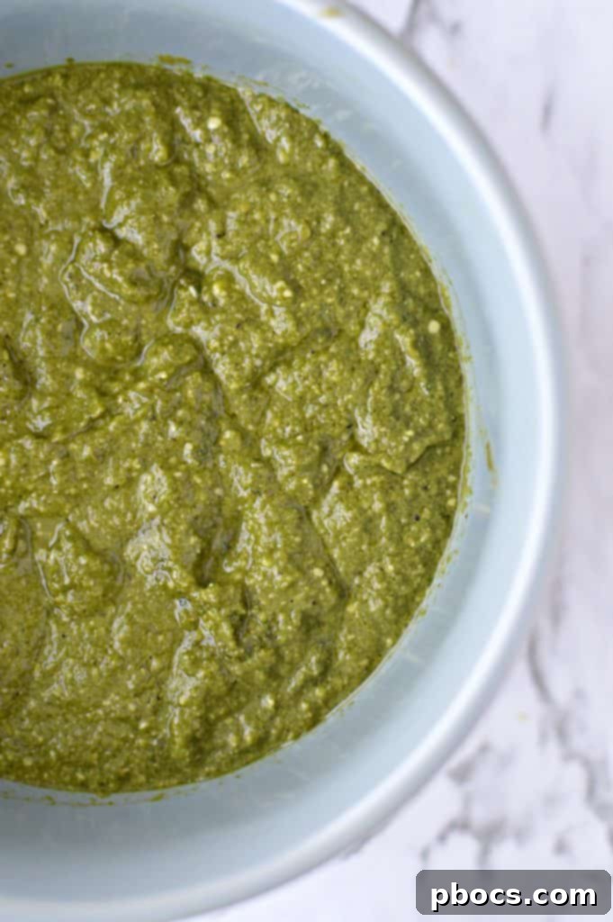 Blending fresh basil, cilantro, and jalapeños for homemade pesto