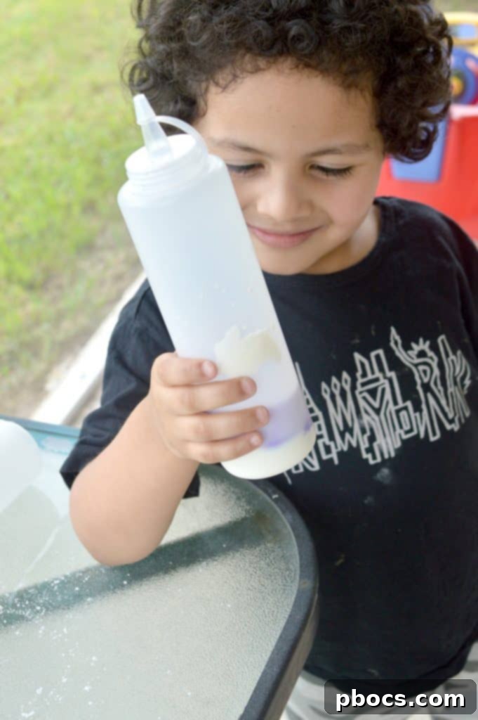Colorful cornstarch paint being poured into containers
