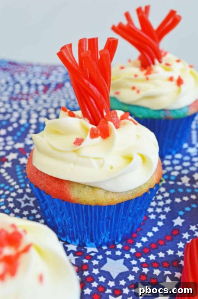 Fireworks Cupcakes Recipe Fireworks Cupcakes Recipe - A close-up of beautifully frosted patriotic cupcakes decorated with pop rocks and Twizzlers.