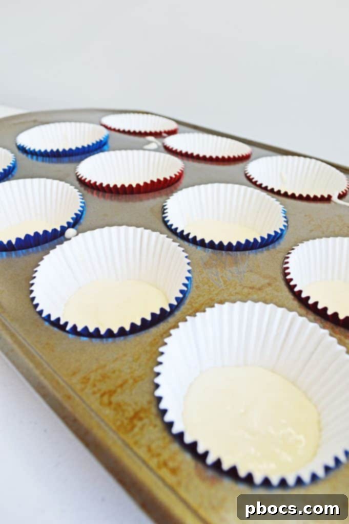Fireworks Cupcakes Recipe Divided cupcake batter in three bowls, colored red, white, and blue.