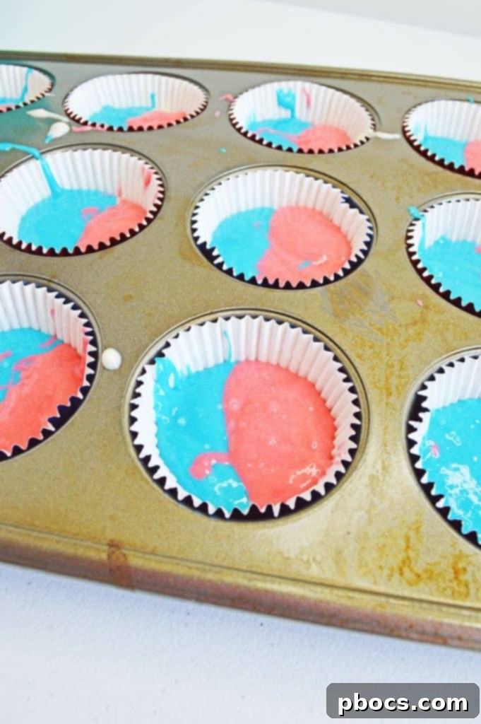 Fireworks Cupcakes Recipe Layering red, white, and blue cupcake batter into liners.