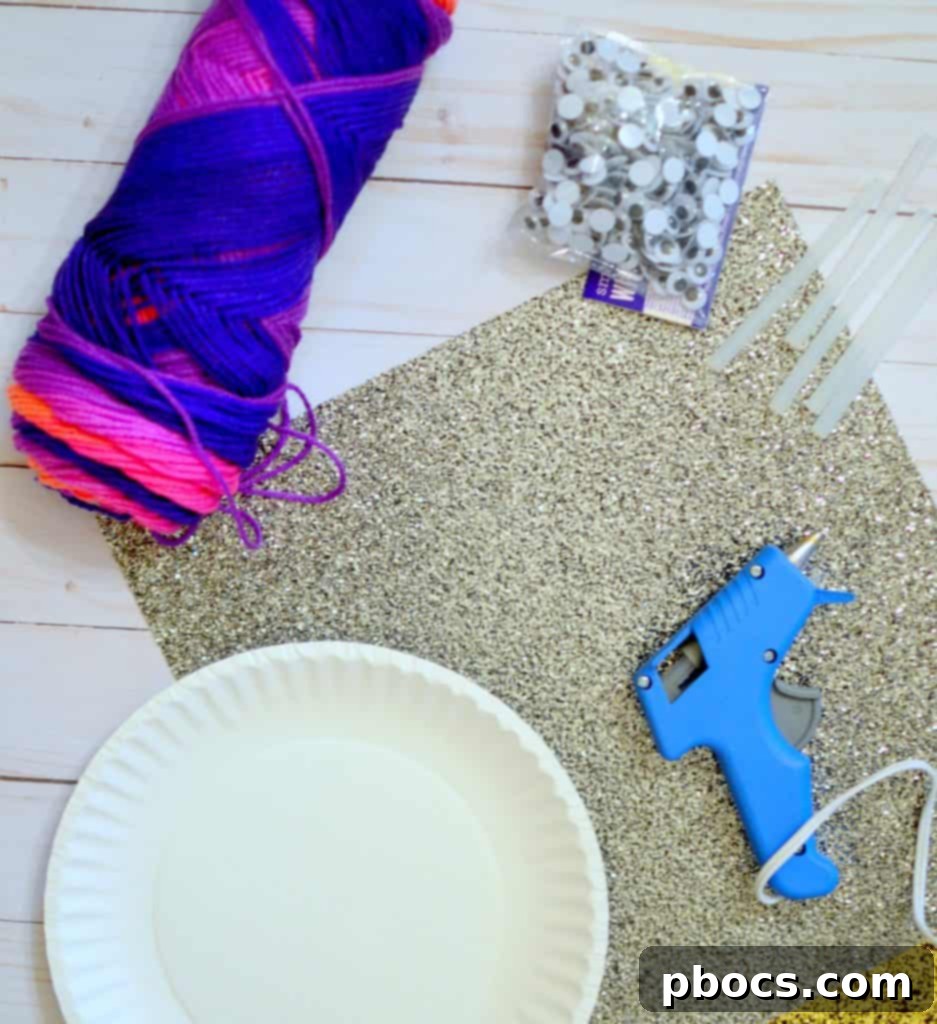 Crafting supplies including paper plates, googly eyes, yarn, scissors, and glue