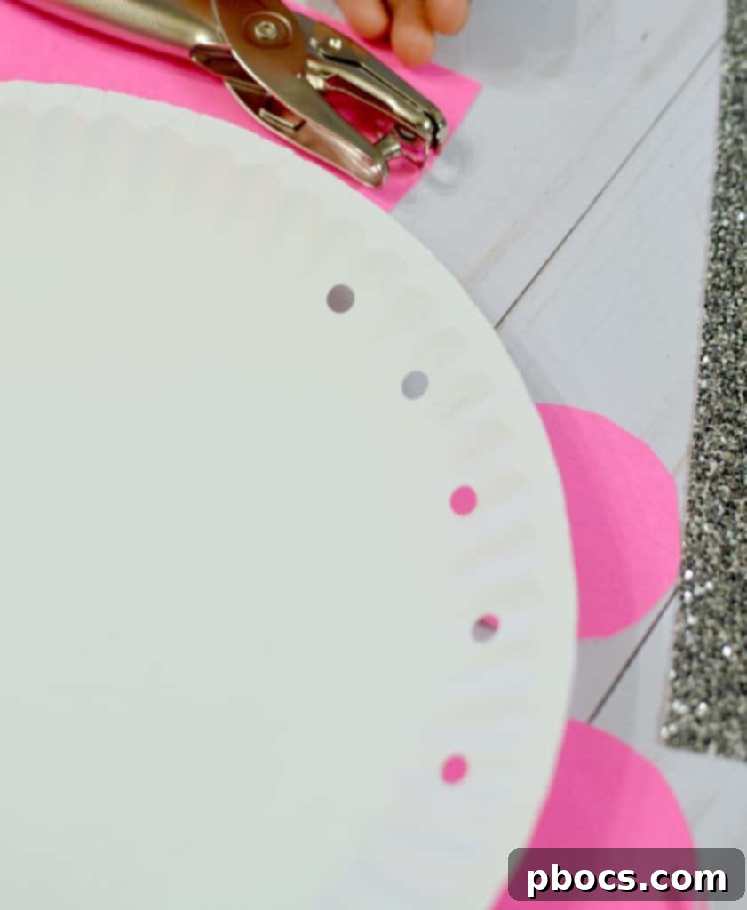 Paper plate with six holes punched along the rim